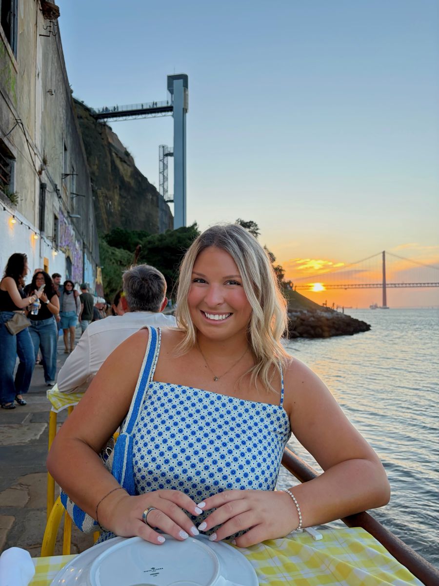 Client smiling at sunset by the water